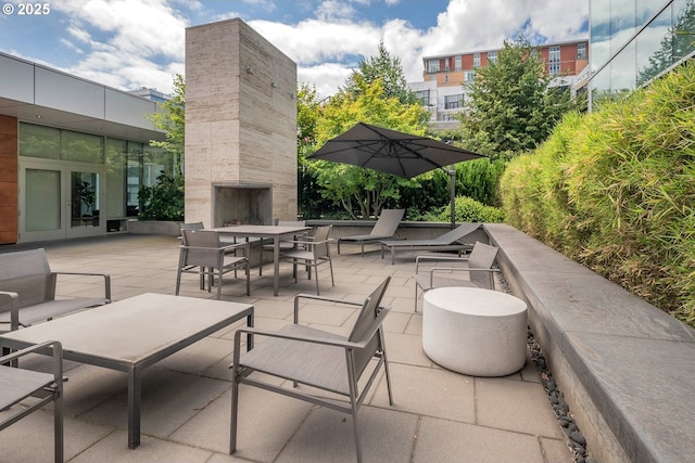 view of patio with an outdoor fireplace