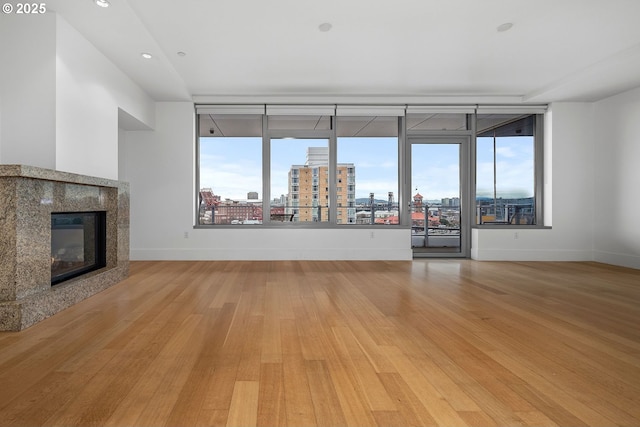 unfurnished living room with a fireplace and light hardwood / wood-style flooring