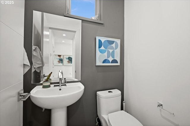 bathroom featuring toilet and a sink