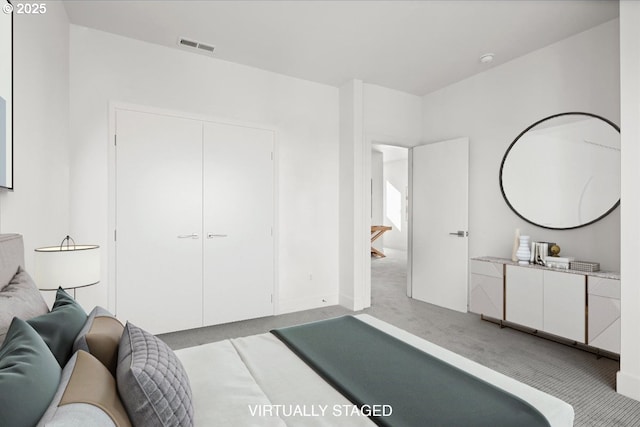 bedroom featuring light carpet and a closet