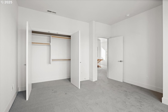 unfurnished bedroom featuring carpet flooring, a closet, and baseboards