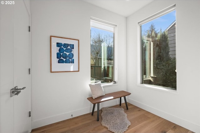 doorway to outside with wood finished floors and baseboards
