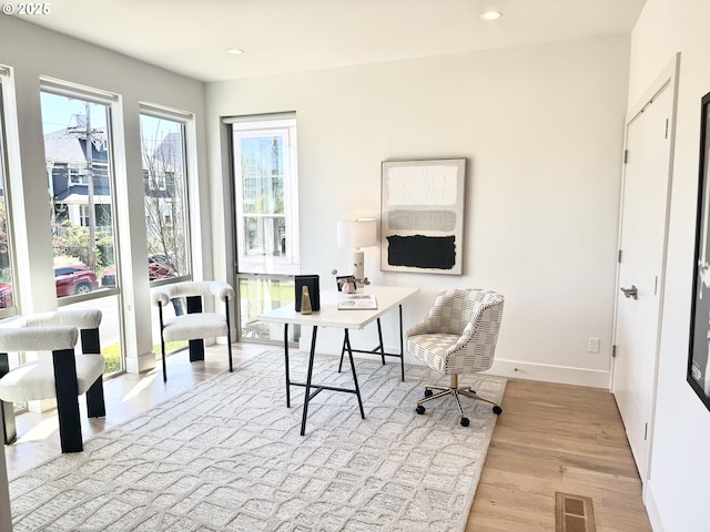 home office featuring light wood-type flooring, baseboards, and recessed lighting