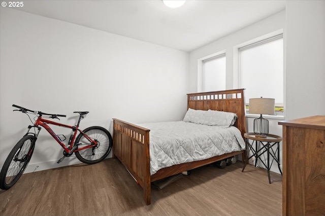 bedroom with wood finished floors and baseboards