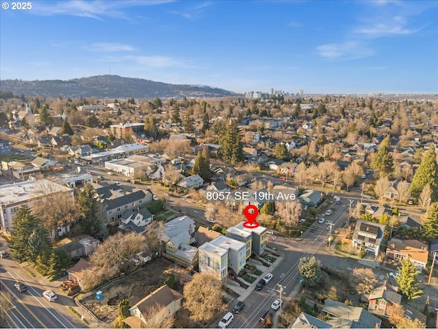 aerial view of property and surrounding area with a mountainous background