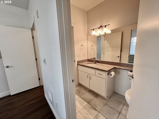 bathroom with toilet and vanity