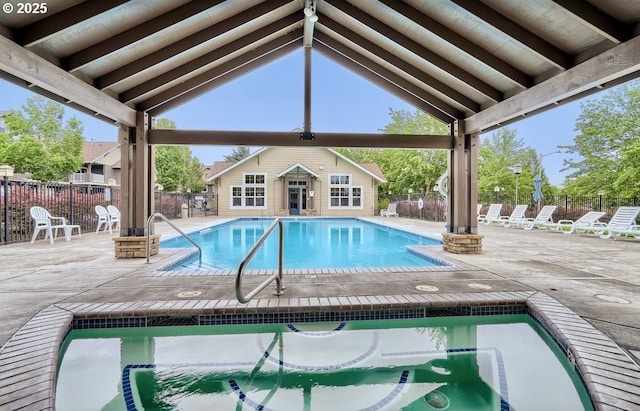 view of swimming pool featuring an outbuilding and a patio area