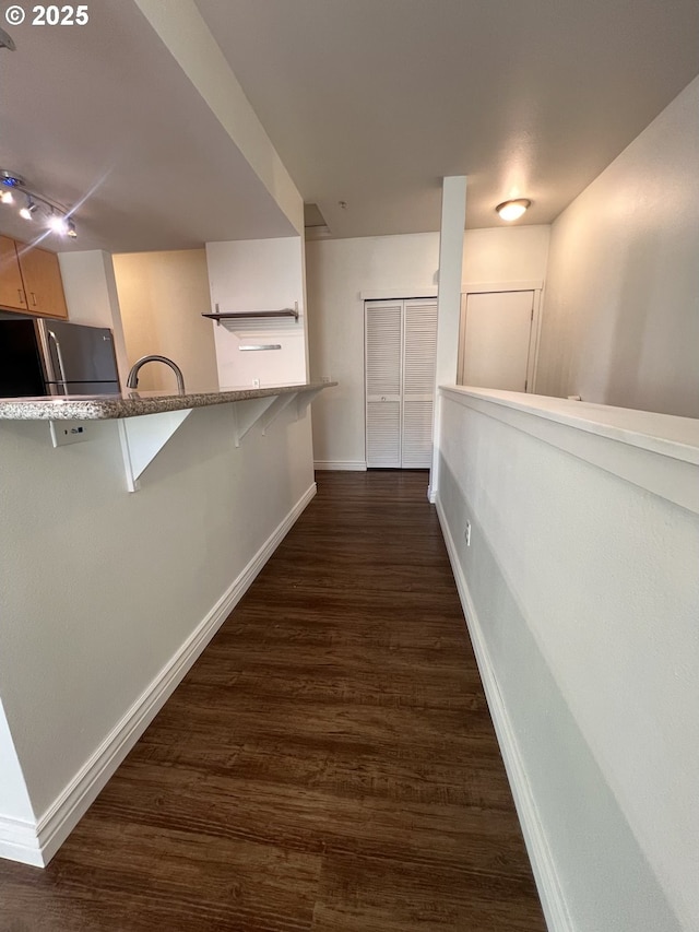 hall with dark wood-type flooring and sink