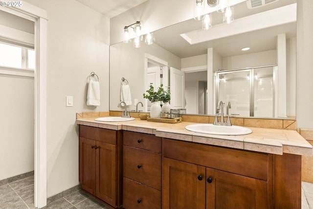 bathroom featuring a shower with door, tile patterned floors, and vanity