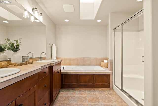 bathroom with vanity, a skylight, and independent shower and bath