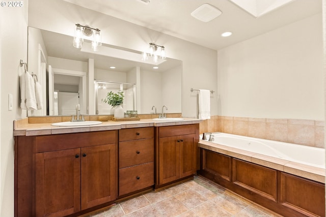 bathroom with vanity and separate shower and tub