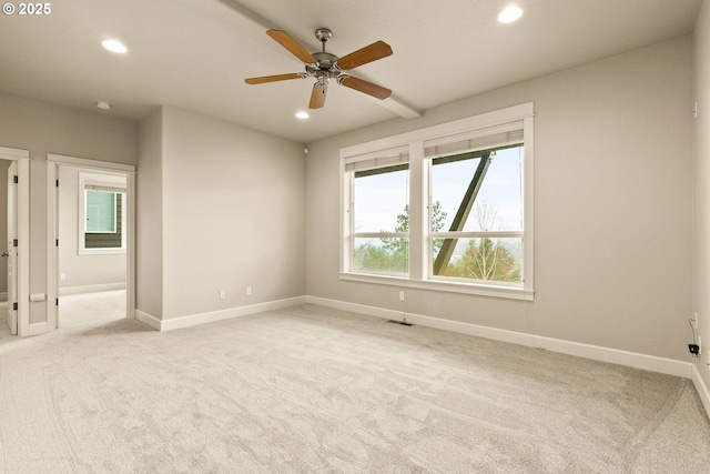 empty room with ceiling fan and light carpet