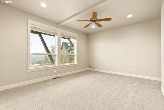 spare room with light carpet, beam ceiling, and ceiling fan