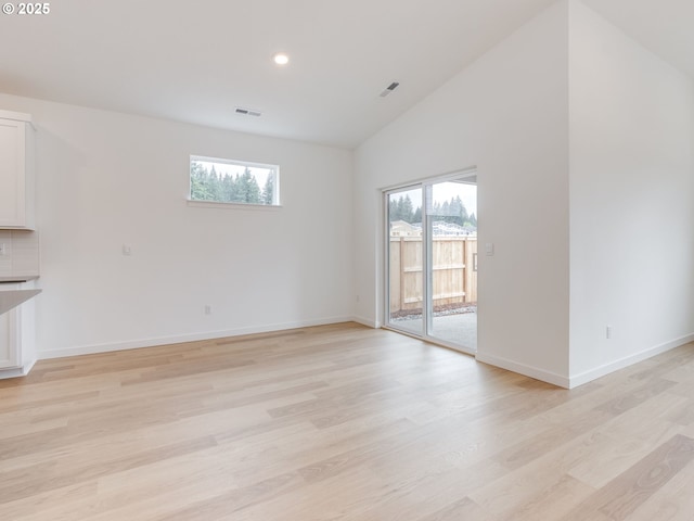 356 NW 29th Way, Battle Ground, WA 98604 - unfurnished living room featuring lofted ceiling, light wood-style floors, baseboards, and recessed lighting