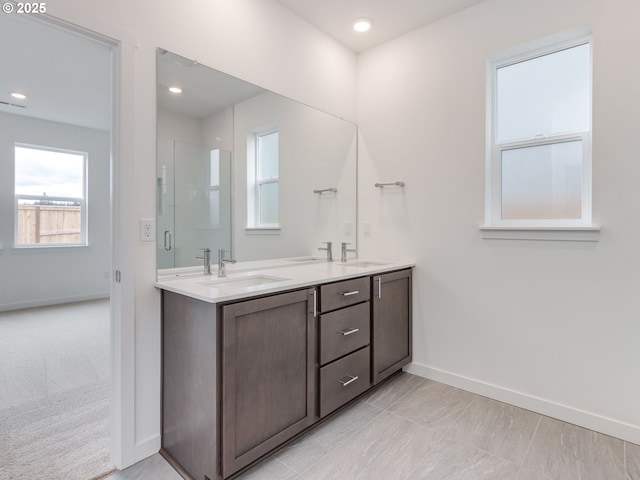 356 NW 29th Way, Battle Ground, WA 98604 - bathroom with baseboards, double vanity, a shower with shower door, and recessed lighting