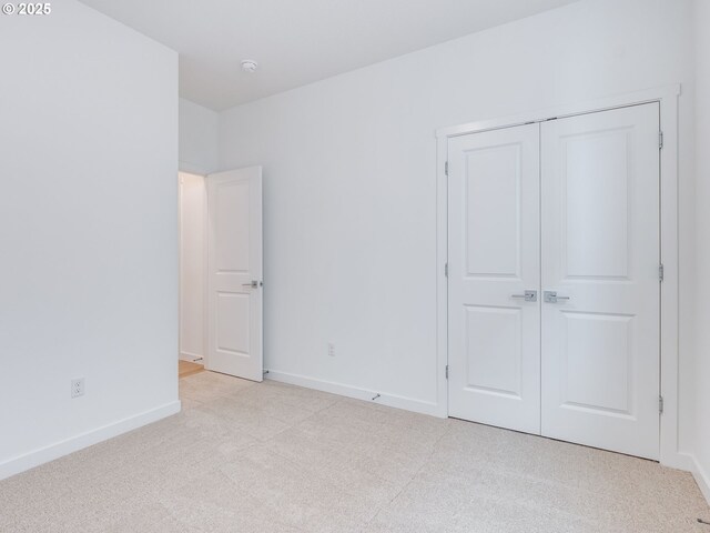 356 NW 29th Way, Battle Ground, WA 98604 - unfurnished bedroom with baseboards, a closet, and light carpet