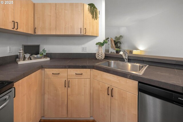 1535 SW Clay St Unit 238, Portland, OR 97201 - kitchen with stainless steel dishwasher, a sink, light brown cabinets, range, and dark countertops