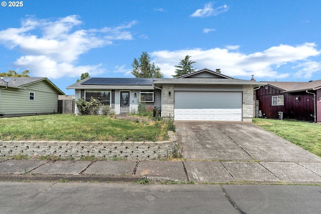 4729 Lariat Ct, Salem, OR 97305 - ranch-style home featuring an attached garage, roof mounted solar panels, driveway, and stone siding