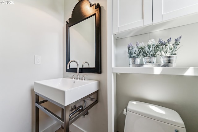 bathroom featuring toilet and vanity