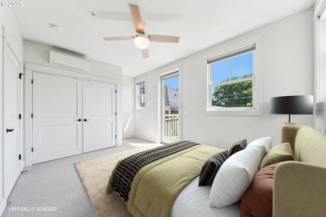 bedroom with a wall mounted AC, access to outside, light carpet, a ceiling fan, and a closet