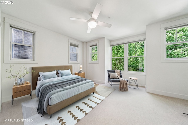 bedroom featuring multiple windows, baseboards, and carpet flooring