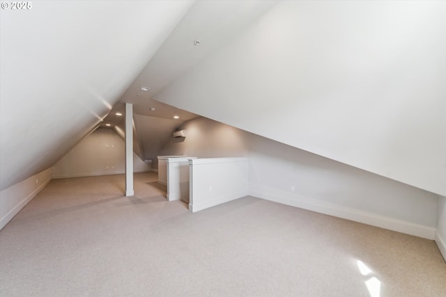 bonus room featuring light colored carpet, lofted ceiling, recessed lighting, and baseboards