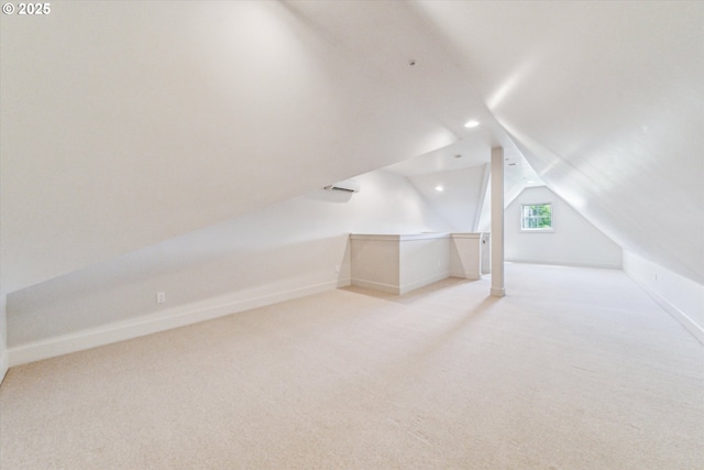 additional living space with light carpet, vaulted ceiling, recessed lighting, and baseboards
