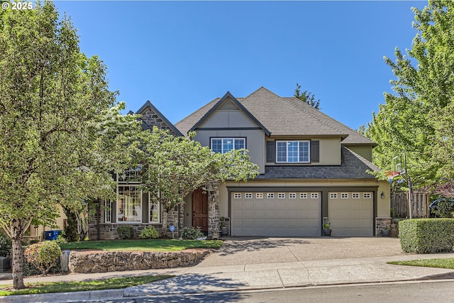 14702 SE Badger Creek Rd, Happy Valley, OR 97086 - view of front of home with stone siding, concrete driveway, stucco siding, and a garage