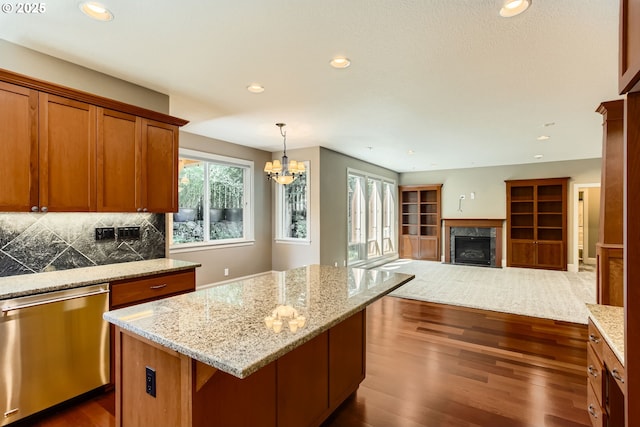 14702 SE Badger Creek Rd, Happy Valley, OR 97086 - kitchen featuring dishwasher, a chandelier, dark wood-type flooring, a premium fireplace, and a kitchen island