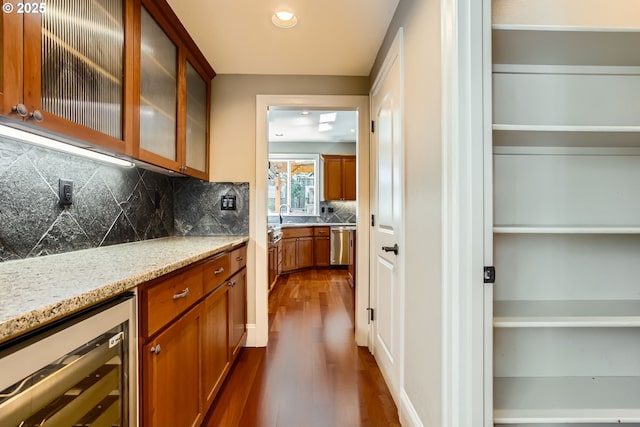 14702 SE Badger Creek Rd, Happy Valley, OR 97086 - bar area with beverage cooler, dark wood-style flooring, decorative backsplash, recessed lighting, and stainless steel dishwasher