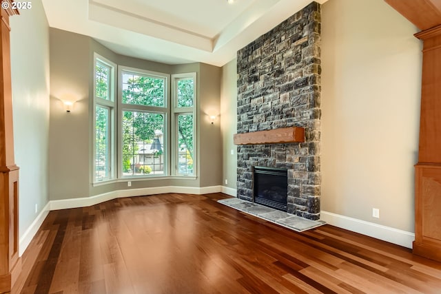 14702 SE Badger Creek Rd, Happy Valley, OR 97086 - unfurnished living room with wood finished floors, plenty of natural light, a fireplace, and a tray ceiling