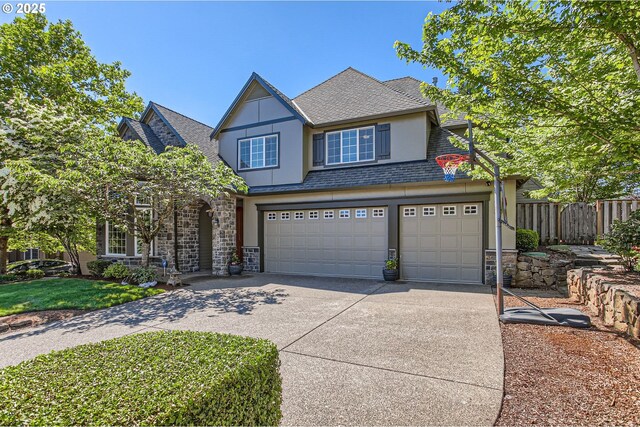 14702 SE Badger Creek Rd, Happy Valley, OR 97086 - view of front of house with concrete driveway, an attached garage, stone siding, stucco siding, and a shingled roof