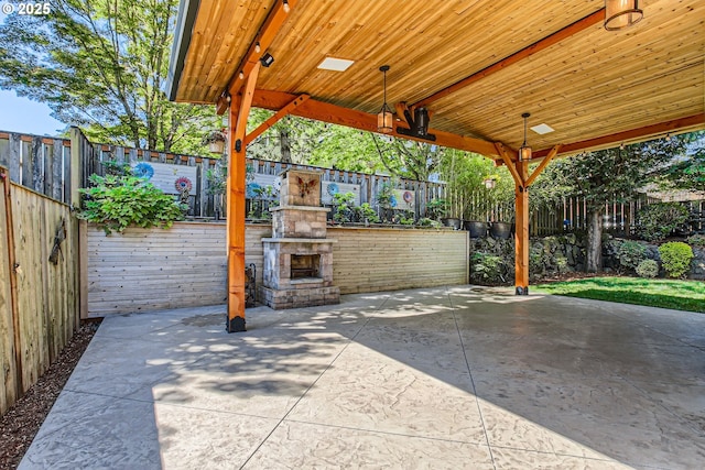 14702 SE Badger Creek Rd, Happy Valley, OR 97086 - fenced backyard featuring an outdoor stone fireplace and a patio area