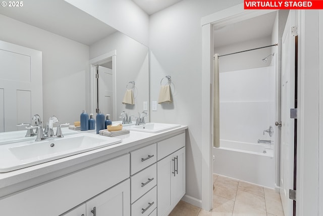 bathroom featuring double vanity, tile patterned flooring, a sink, and shower / bathing tub combination