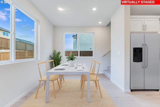 dining room featuring light wood-type flooring, stairway, baseboards, and recessed lighting