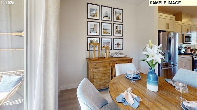 dining room featuring baseboards and light wood-type flooring