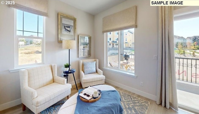 living area featuring wood finished floors and baseboards