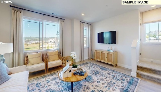 living room featuring recessed lighting, stairs, light wood-type flooring, and baseboards