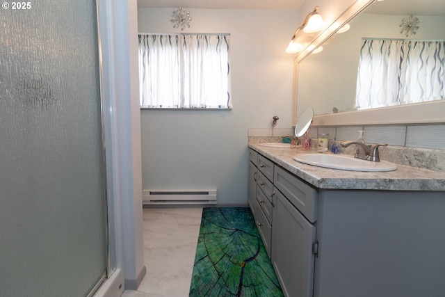 1896 W Park Dr, Florence, OR 97439 - bathroom with baseboard heating, double vanity, marble look tile flooring, and a shower with shower door