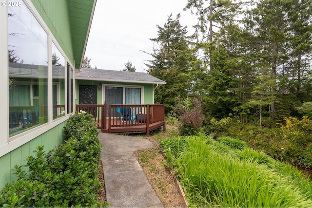 1896 W Park Dr, Florence, OR 97439 - property entrance with a deck and a shingled roof