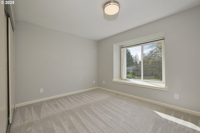 spare room with carpet floors and baseboards