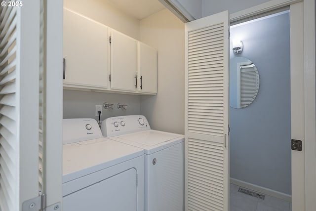 washroom with visible vents, baseboards, independent washer and dryer, cabinet space, and tile patterned flooring
