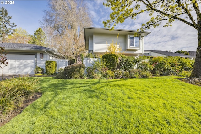 exterior space with a garage, a yard, and fence