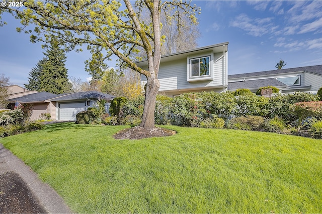 view of front of house with a garage and a front yard