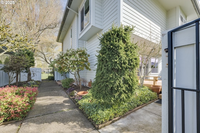 view of home's exterior featuring fence and a gate