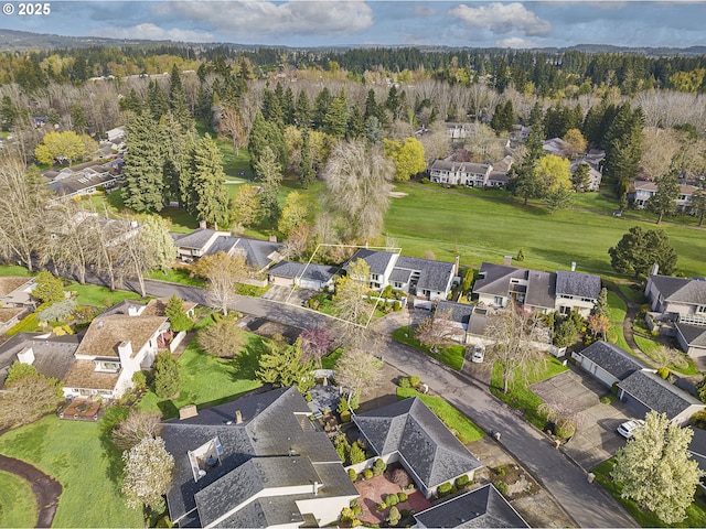 aerial view featuring a view of trees and a residential view