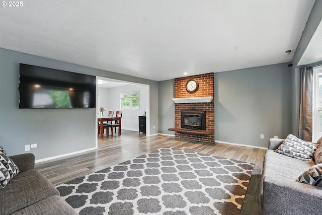 6816 NE 65th Ave, Vancouver, WA 98661 - living area featuring wood finished floors, a fireplace, and baseboards