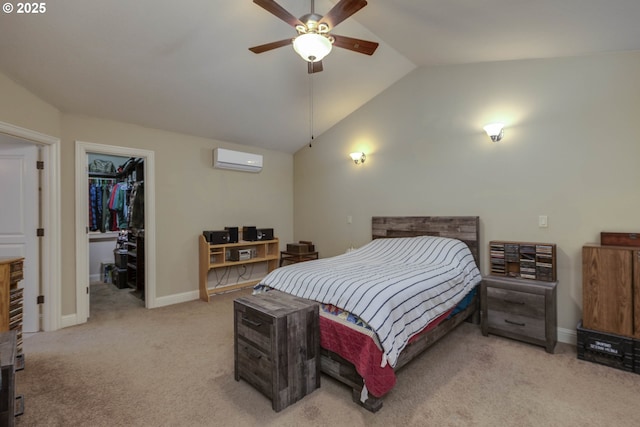 carpeted bedroom featuring a wall mounted air conditioner, baseboards, lofted ceiling, and a spacious closet