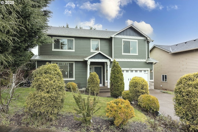 craftsman-style home featuring roof with shingles, an attached garage, concrete driveway, a front lawn, and board and batten siding