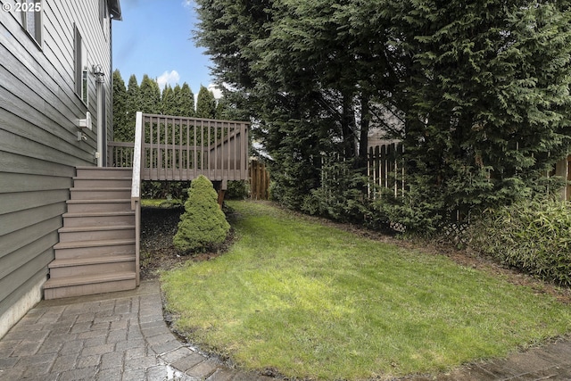 view of yard featuring stairway, a wooden deck, and fence